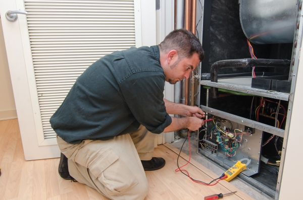 Service technician working on a residential AC unit