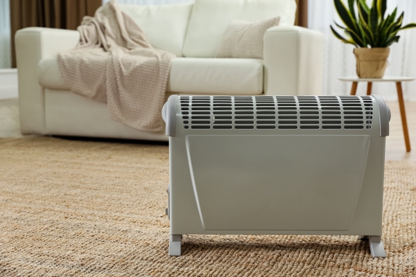 Modern electric convection heater on living floor of a residential home